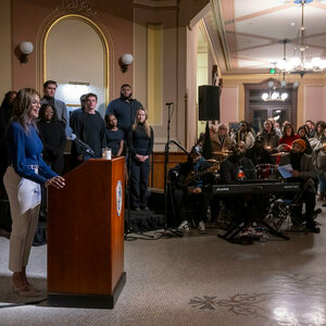 Salima Rockwell, Notre Dame volleyball head coach, speaks at a podium in the Main Building Rotunda.